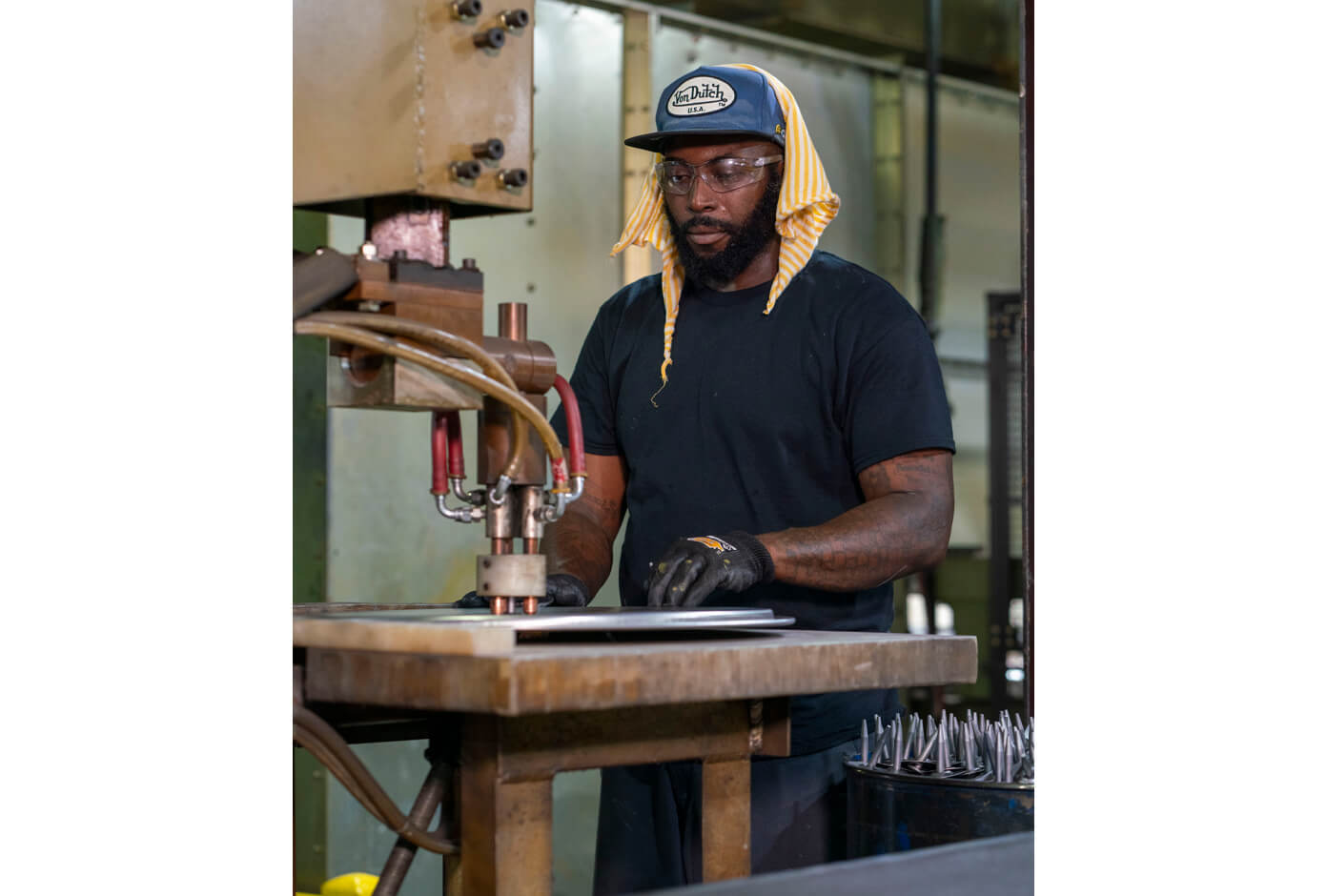 Employee creating customized steel drum