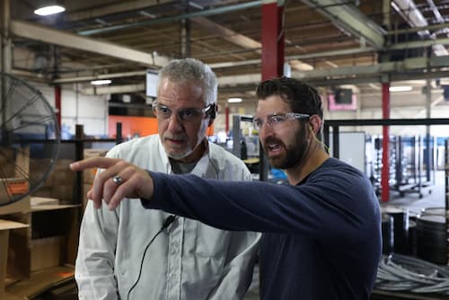 Cody Stavig speaking with employee