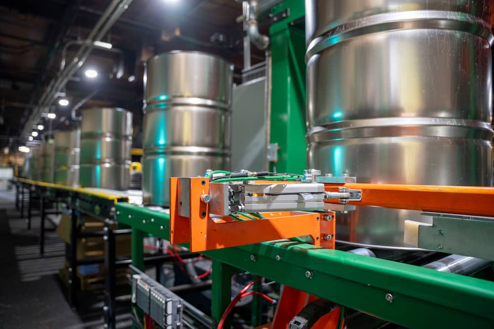 steel drums on conveyor belt