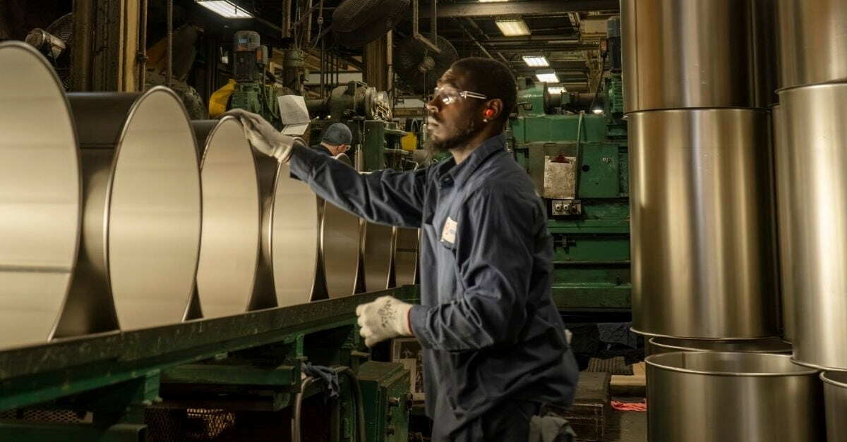 NCC employee working on a 55-gallon steel drum for oil and lubricants
