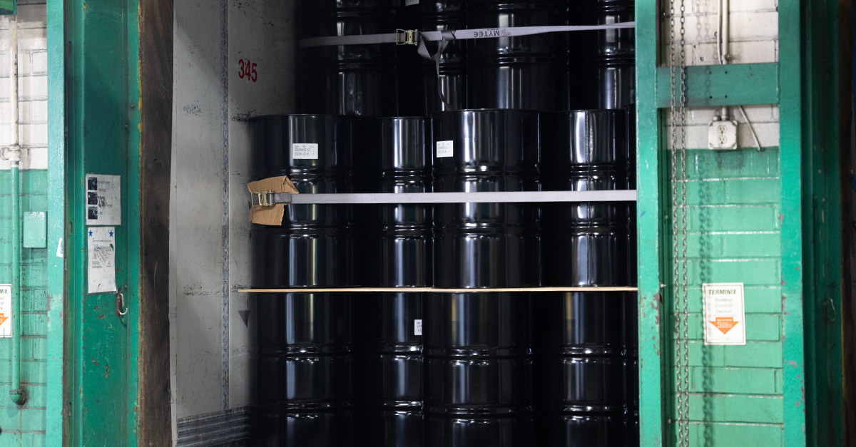 55-gallon drums stacked at a warehouse for the use of transporting hazardous chemicals