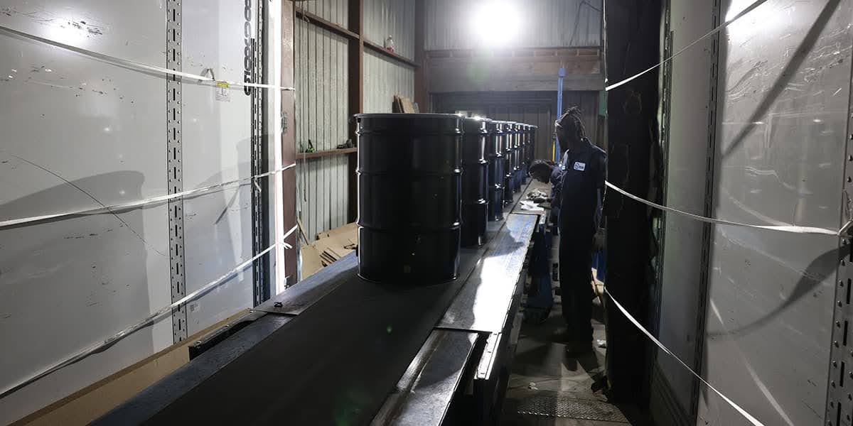 55 gallon steel drums delivered by drop trailer at a 24/7 production facility