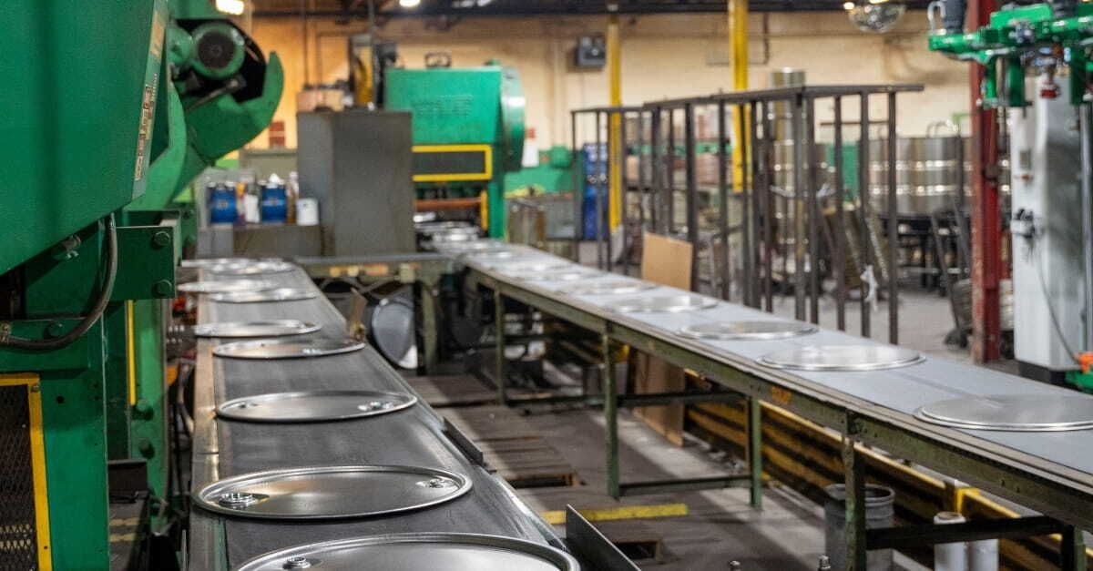Steel drum lids on production line at an NCC facility